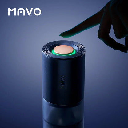 Finger pressing the one-touch start button on the MAVO Aurora grinder, ring light glowing green