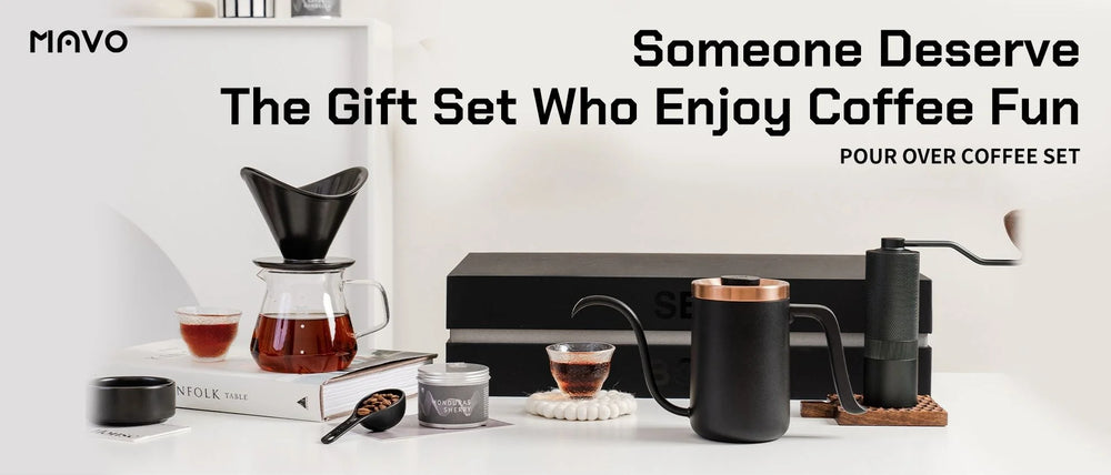 MAVO Pour Over Coffee Set arranged on a shelf: gooseneck kettle, hand grinder, winged dripper on a glass server, tasting cups and the gift box