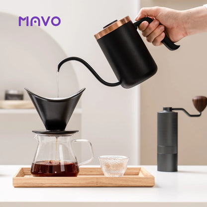 Pouring from the copper-rimmed Deep Flow Pro gooseneck kettle into the winged dripper on a glass server, Wizard grinder alongside