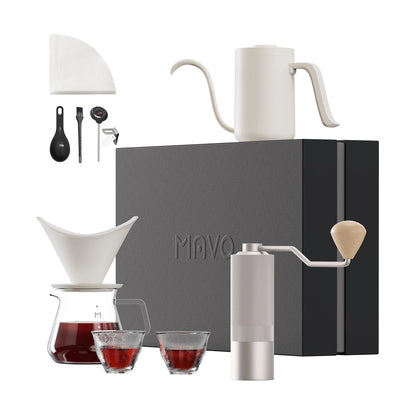 MAVO Pour Over Coffee Set in White: white gooseneck kettle, white winged ceramic dripper on a glass server, silver Wizard hand grinder, two tasting cups and accessories in front of the gift box