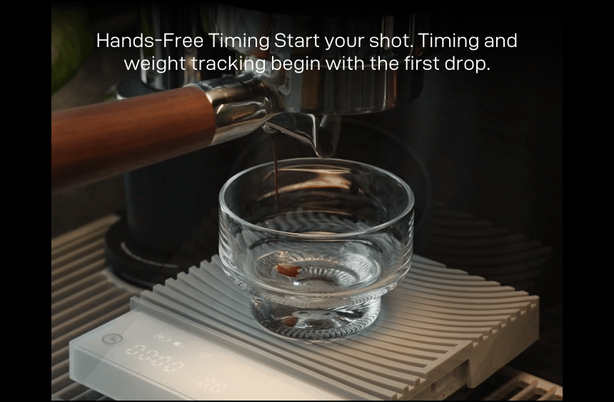 Hands-Free Timing: espresso pouring into a glass on the Basic 3 — 'Start your shot. Timing and weight tracking begin with the first drop.'