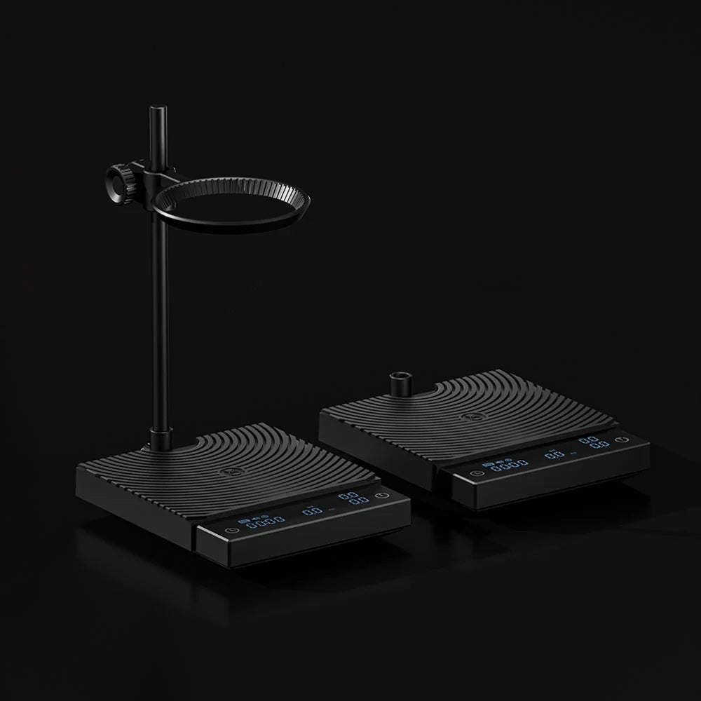 Two black TIMEMORE scales side by side on a black background, the DUO with its dripper arm at left