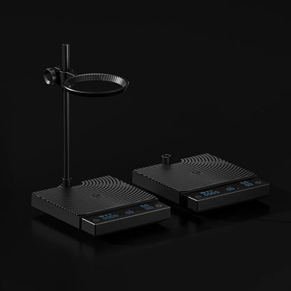 Two black TIMEMORE scales side by side on a black background, the DUO with its dripper arm at left