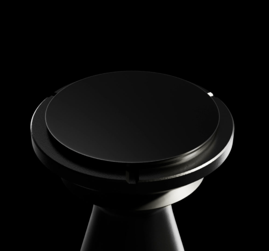 Animated: the Flow tamper's flat base seen from above, rotating slowly on a black background