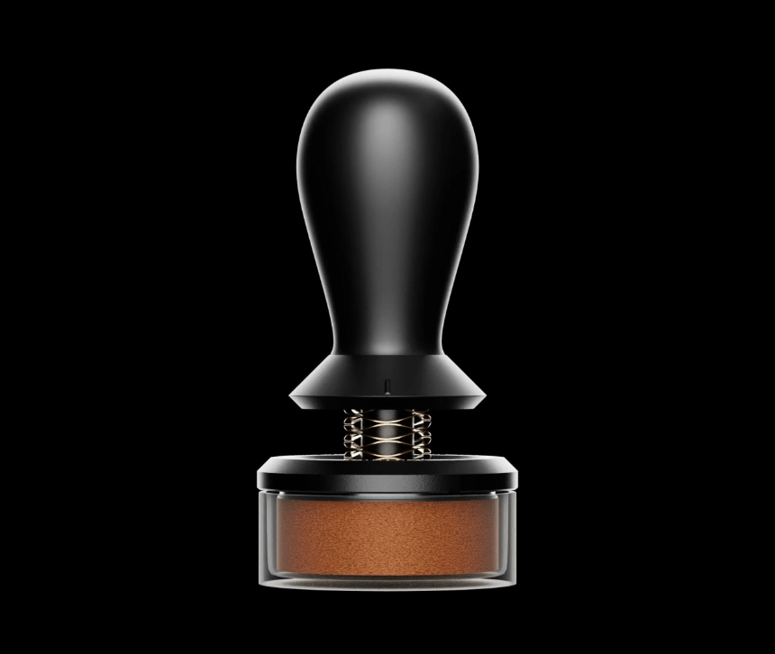Animated: the Flow tamper with its gold spring visible above a coffee-filled base turning on a black background
