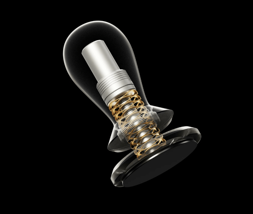 Animated: a see-through cutaway of the Flow tamper showing the gold wave spring and metal shaft inside a bulb-shaped body