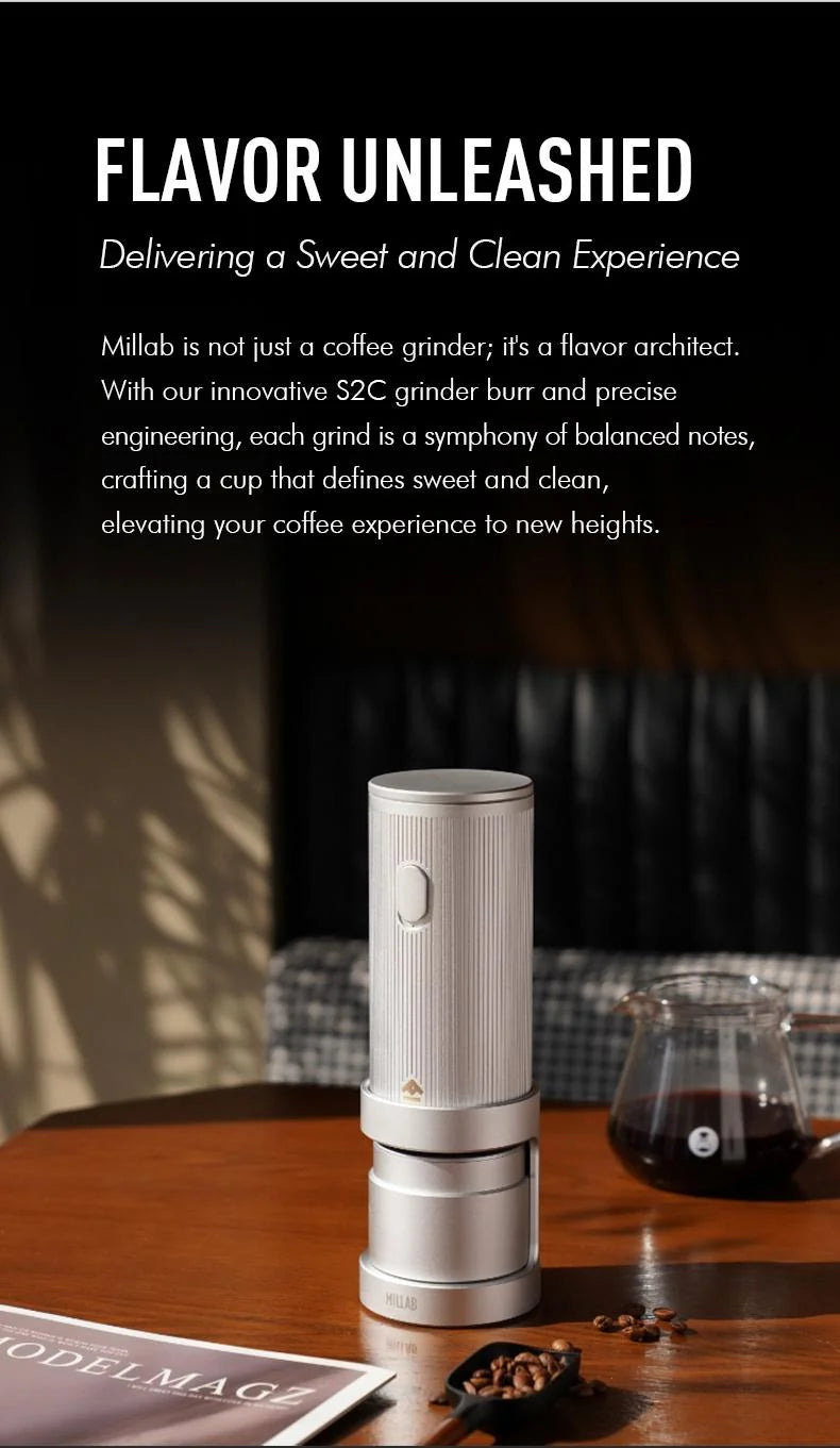 Flavor unleashed: silver MILLAB E01 on a café table beside a glass server of filter coffee