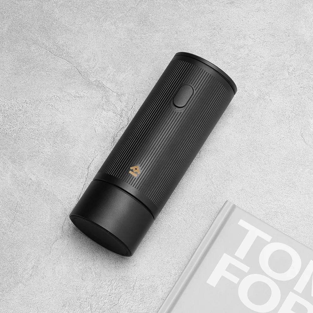 TIMEMORE x MILLAB E01 grinder body lying on a grey stone surface beside a magazine