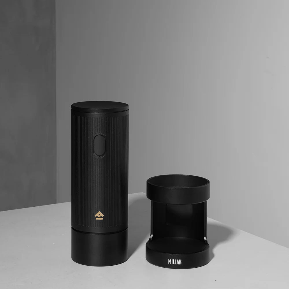 TIMEMORE x MILLAB E01 grinder body standing next to its empty stand on a white worktop