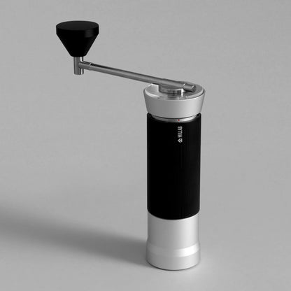 TIMEMORE x MILLAB M01 hand grinder in Silver with black grip and black knob, three-quarter view on a grey studio background