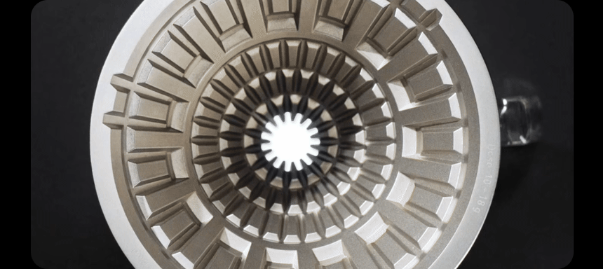 Animation from above of a white 01 paper filter settling into the VECTOR's stainless steel lattice