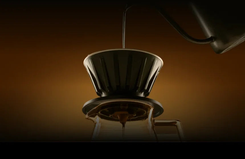 Gooseneck kettle pouring into the black VECTOR dripper on a glass server, coffee dripping through in warm studio light